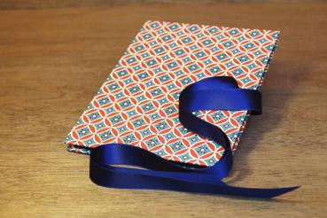 Mini photo album with graphic diamond pattern, red, white, blue, blue ribbon